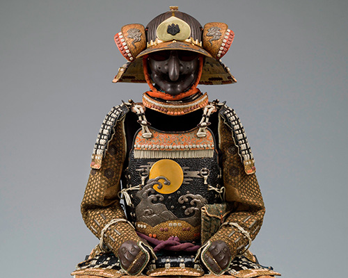 A suit of armor with ornate helmet and wave motif on the chest